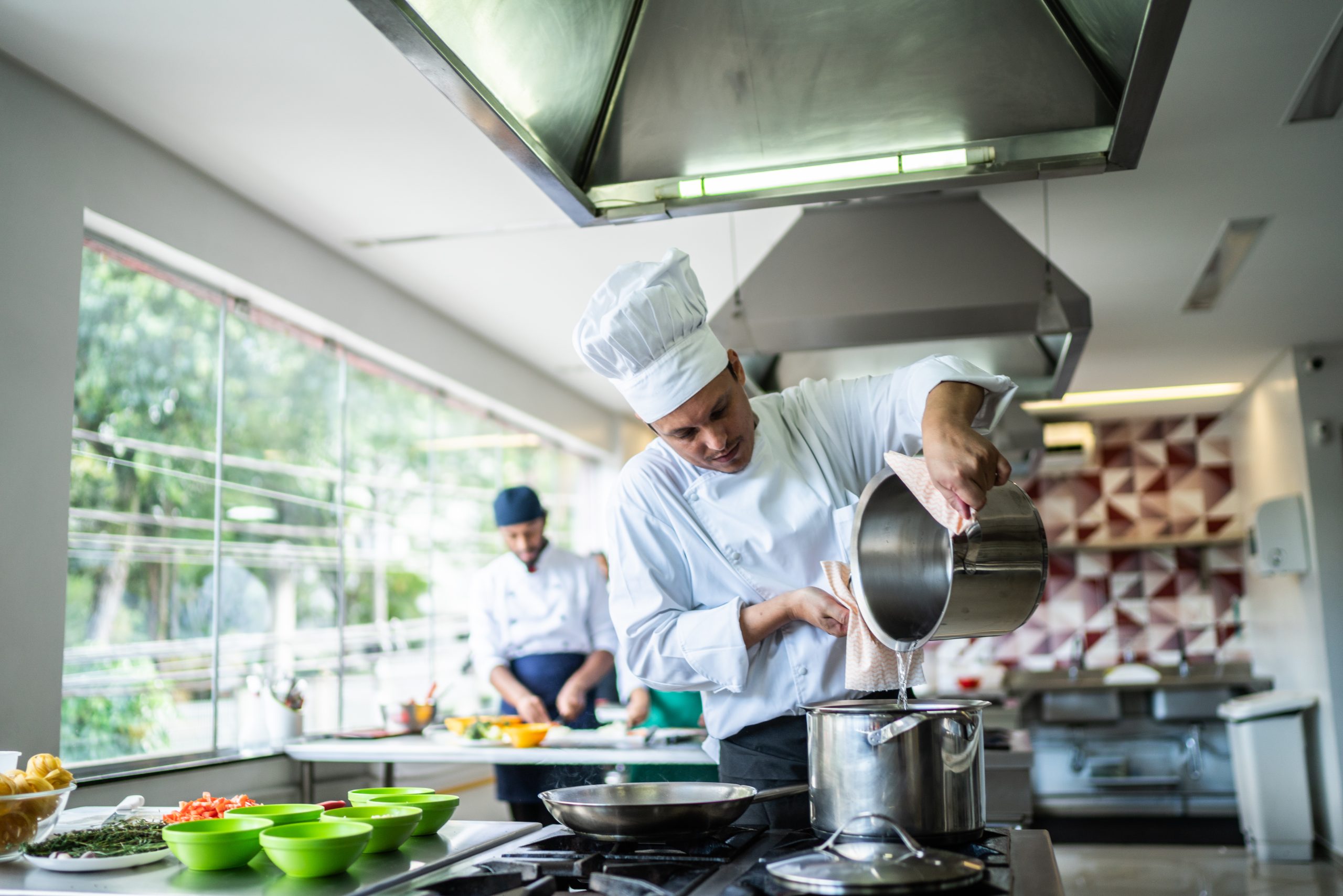 Chef preparing in the kitchen powered by Pentair Restaurant & Cafe Foodservice Water & Ice Solutions