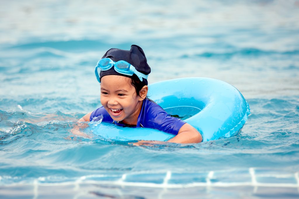 Asian girl smiling in a pool powered by Pentair Solusi Perkolaman