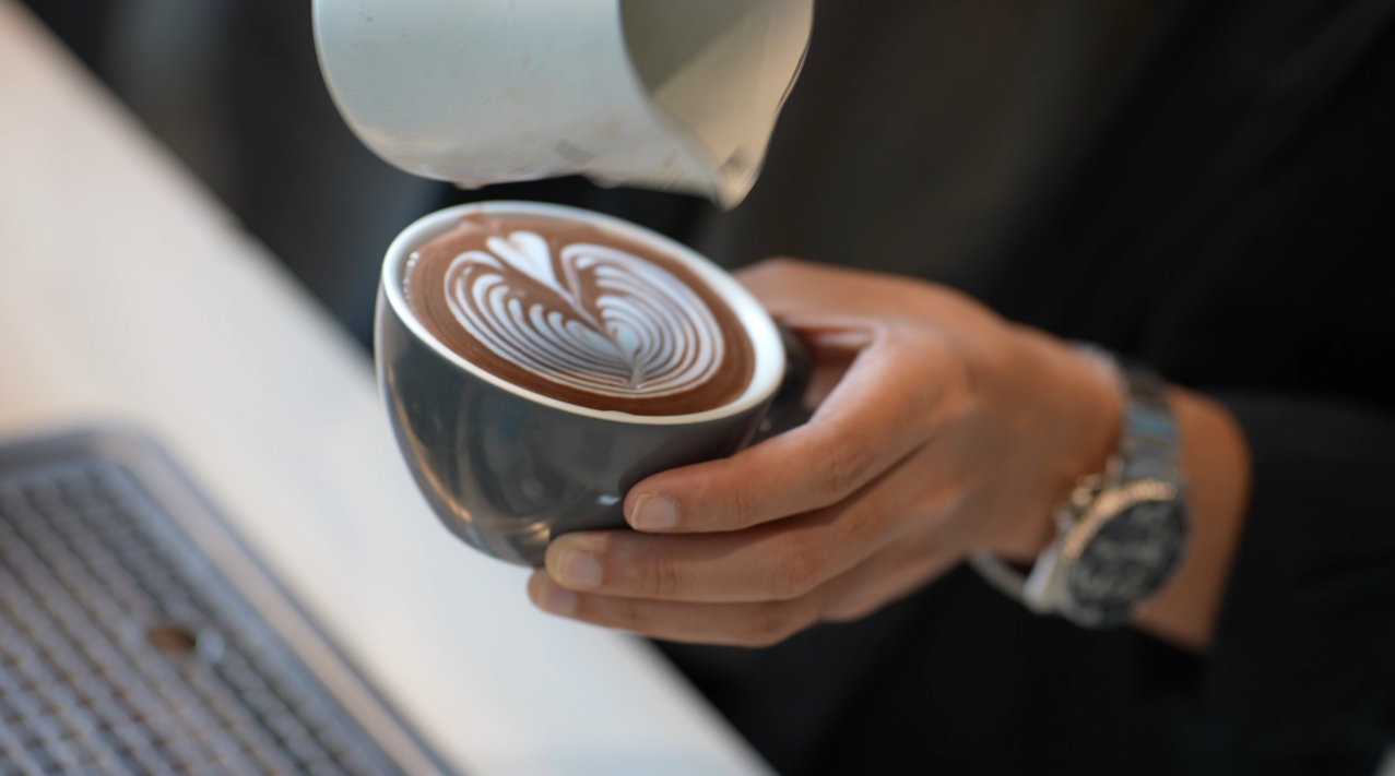 Person pouring water into coffee powered by Pentair Water Filtration Solutions