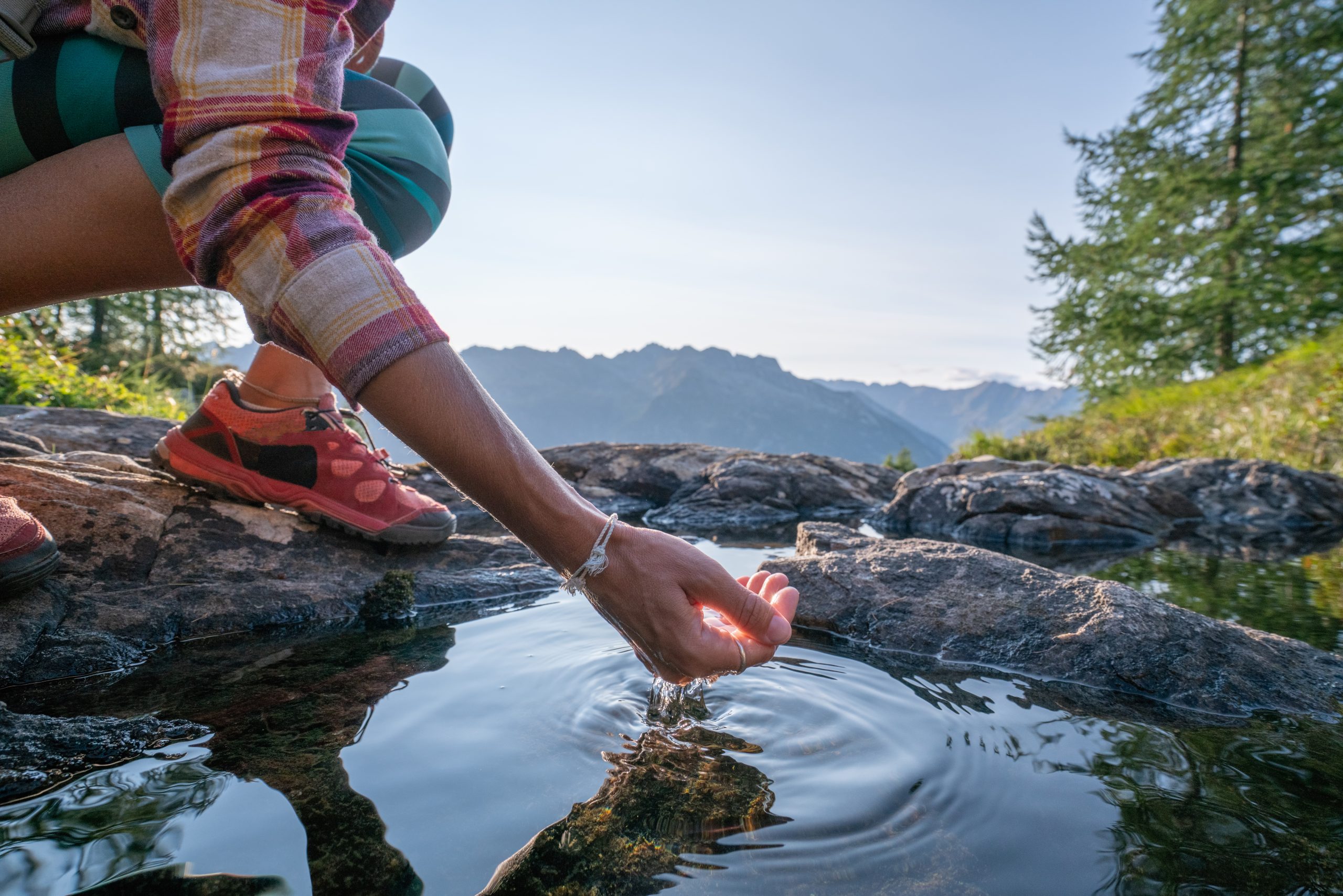 Human hand cupped to catch the fresh water from the lake, displaying the freshness and high quality water solutions from Pentair
